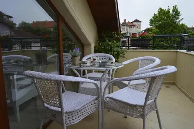 a table and chairs sitting on a balcony at Apartments Dona in Chernomorets