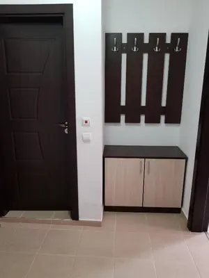a room with a black door and a cabinet with mirrors at Family Aparthotel Vintegra in Burgas City