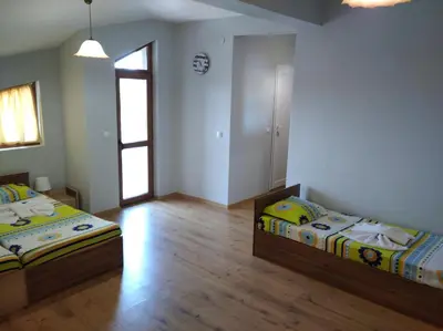 a bedroom with two beds and a window at Guest House Niya Chernomorets in Chernomorets