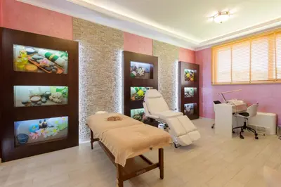 a room with a dental office with a chair and a table at VILLA FLORENCE Boutique Apart Hotel in Sveti Vlas