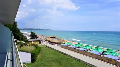 a view of a beach with umbrellas and the ocean at Aurora apartments on the beach in Obzor