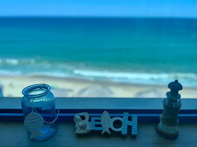 a blue glass jar next to a chessisel and a chess at Aurora apartments on the beach in Obzor