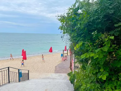 a group of people on a beach with umbrellas at Complex Terazini in Byala