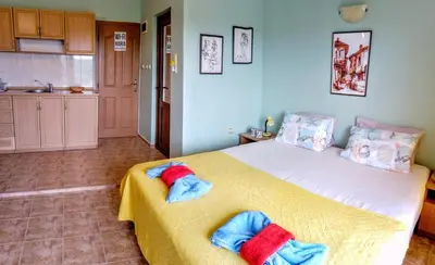 a bedroom with a bed with two towels on it at Guest House Maria in Nesebar