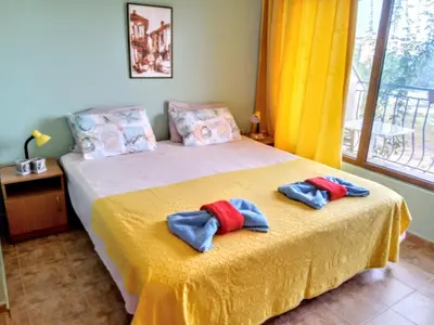a bedroom with a bed with two pillows on it at Guest House Maria in Nesebar
