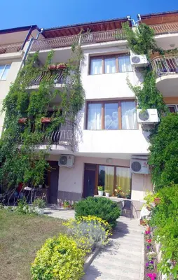 a white building with plants on the side of it at Guest House Maria in Nesebar