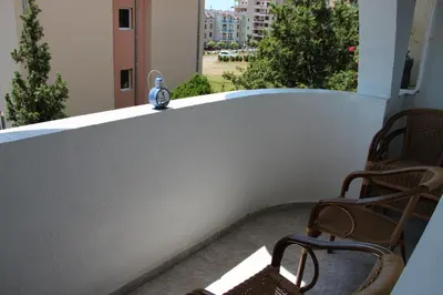 a clock sitting on the ledge of a balcony at Karchevi Apartment in Sveti Vlas