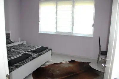 a bedroom with a bed and a window at Karchevi Apartment in Sveti Vlas
