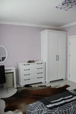a bedroom with a white cabinet and a desk at Karchevi Apartment in Sveti Vlas