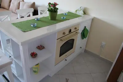 a kitchen island with a stove in a living room at Karchevi Apartment in Sveti Vlas