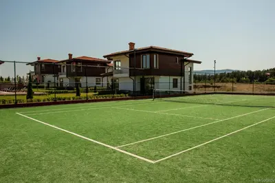 a tennis court in front of a house at Villas in Complex Trakiyskiy Bryag in Lozenets