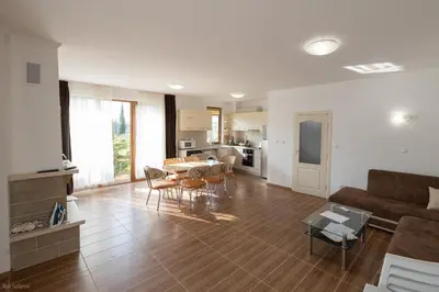 a living room with a couch and a table and chairs at Villas in Complex Trakiyskiy Bryag in Lozenets