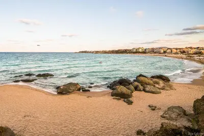 a sandy beach with rocks and the ocean at Villas in Complex Trakiyskiy Bryag in Lozenets