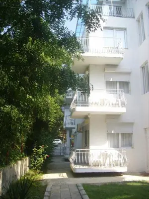 a white building with balconies on the side of it at Lurd Family Hotel in Lozenets