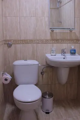 a bathroom with a toilet and a sink at Beach Apartment MELINA in Pomorie