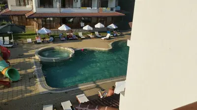 an overhead view of a swimming pool with chairs and umbrellas at Apartments Resort BG in Primorsko