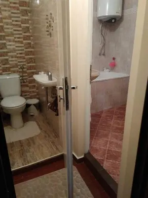 a bathroom with a toilet and a sink at Dom Eli in Pomorie