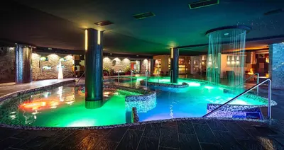 a large swimming pool in a building with aperature at Grand Hotel Sveti Vlas - Fitness & SPA Hotel in Sveti Vlas