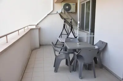 a small balcony with a table and chairs at Aparthotel Lucky Family in Ravda