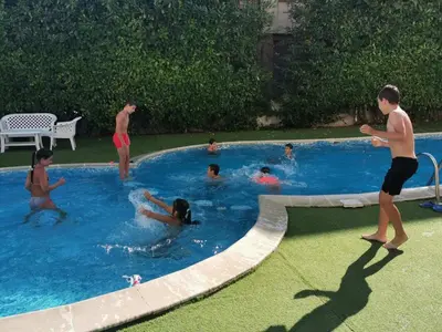 a group of people playing in a swimming pool at Aparthotel Lucky Family in Ravda