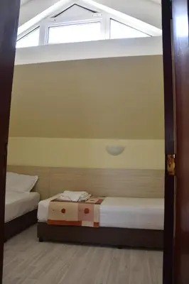 two beds in a room with a window at Aparthotel Lucky Family in Ravda