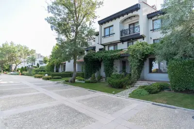 a house with ivy on the side of a street at Oasis Resort & Spa Cozy Apartments in Lozenets