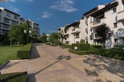 a walkway between two buildings in a park at Oasis Resort & Spa Cozy Apartments in Lozenets