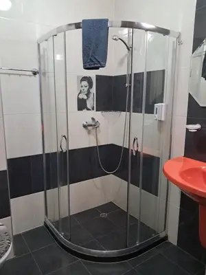 a shower with a glass door in a bathroom at Apart Hotel Iglika in Pomorie