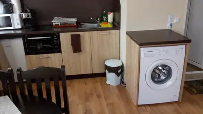 a kitchen with a washing machine next to a counter at Villa Maria in Tsarevo
