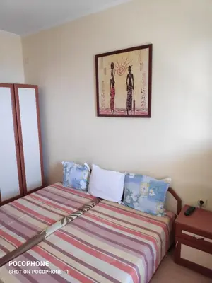a bedroom with a bed and a picture on the wall at Homestay Kostadinov in Pomorie