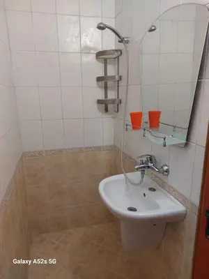 a bathroom with a sink and a mirror at Homestay Kostadinov in Pomorie