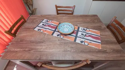 a wooden table with a bowl on top of it at Flat Lora Pomorie in Pomorie