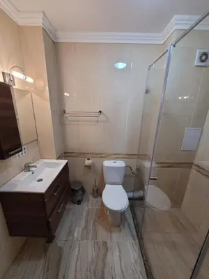a bathroom with a toilet and a shower and a sink at семеен хотел Прованс Ахелой in Aheloy