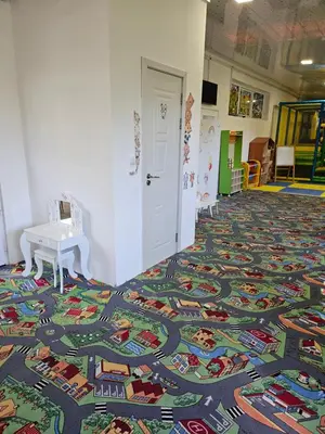a room with a colorful rug on the floor at семеен хотел Прованс Ахелой in Aheloy