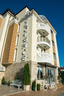 a hotel with a sign on the side of it at семеен хотел Прованс Ахелой in Aheloy