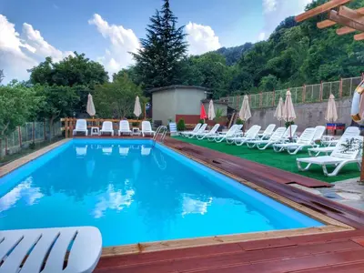 a large swimming pool with chairs and umbrellas at Complex Fichoza in Varna City