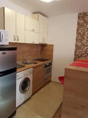 a kitchen with a sink and a washing machine at Apartment Kraev in Primorsko