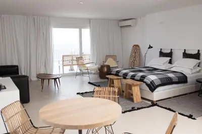 a bedroom with a bed and a table and chairs at Sea Sense Boutique Villa & Relax Zone in Sozopol