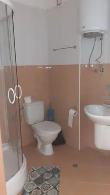 a bathroom with a toilet and a sink and a shower at Complex Oazis in Ravda