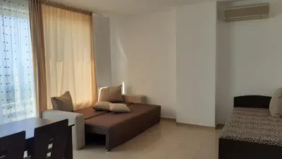 a living room with a couch and a chair at Complex Oazis in Ravda