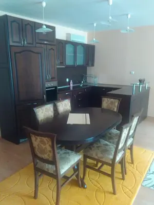a kitchen with a black table and chairs at Complex Oazis in Ravda