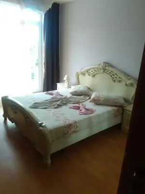 a bedroom with a bed with a white bed frame at Complex Oazis in Ravda