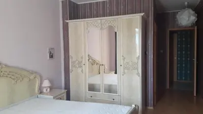 a bedroom with a white cabinet with a mirror at Complex Oazis in Ravda