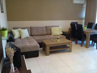 a living room with a couch and a table at Apartments in Complex Panorama in Sozopol
