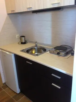 a kitchen with a sink and a counter top at Guest House SNG in Nesebar