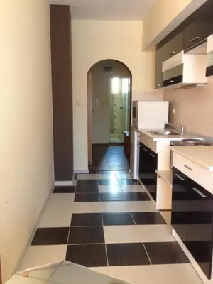a kitchen with a black and white checkered floor at Guest House SNG in Nesebar
