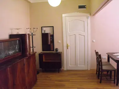 a living room with a tv and a table and a door at Julia Garden in Burgas City