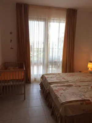 a bedroom with two beds and a large window at Apartment on the sea at St Nikolas Complex-Veronika in Chernomorets