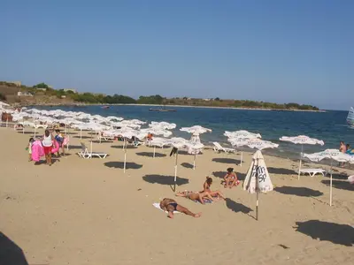 a group of people on a beach with umbrellas at Apartment on the sea at St Nikolas Complex-Veronika in Chernomorets