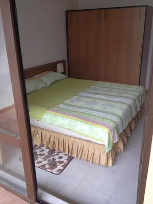 a bedroom with a bed with a wooden frame at Apartment on the sea at St Nikolas Complex-Veronika in Chernomorets